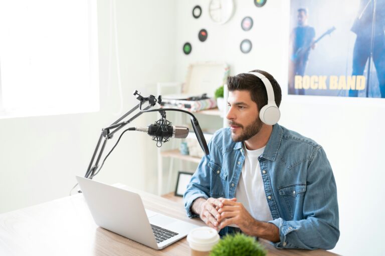 Un hombre sosteniendo un micrófono y practicando su discurso con expresión concentrada, entrenando sus habilidades de comunicación verbal.