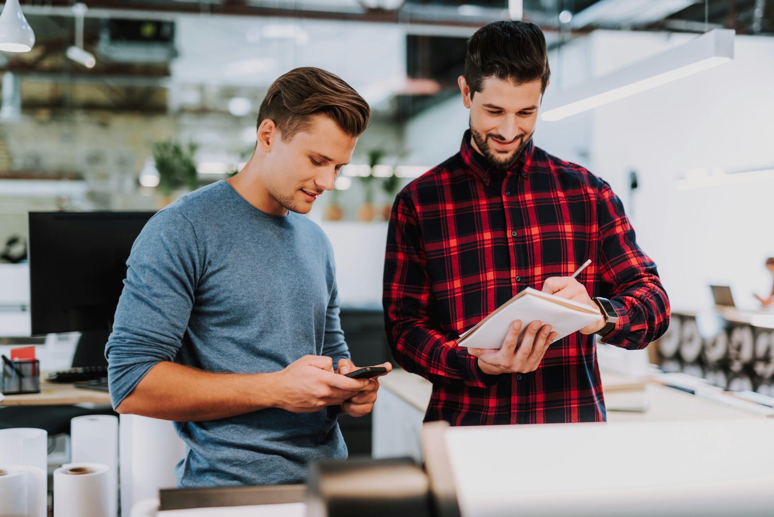Dos emprendedoras anotando consejos sobre cómo contratar freelancers online.