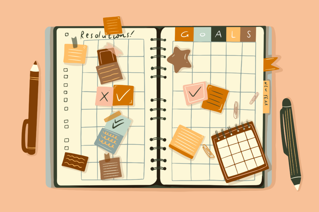 Un diario de estilo bullet journal abierto sobre una superficie, decorado con pegatinas de estrellas y varias notas adhesivas de colores para la organización de tareas.